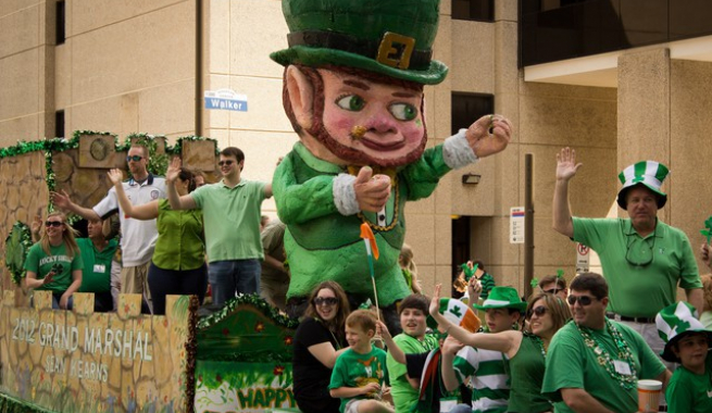 St Patricks Day Parade Float with waving people and giant leprechaun